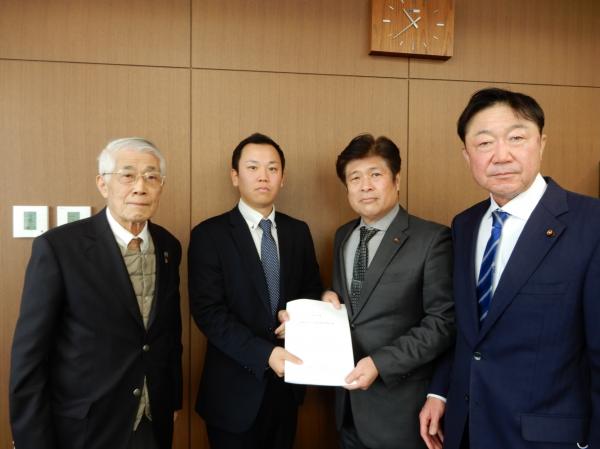 西上議長、山本副議長に対し、小野代表監査委員、尾川監査委員が報告書を渡している写真